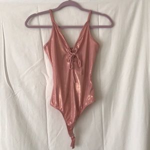 Pink, shiny, body suit.